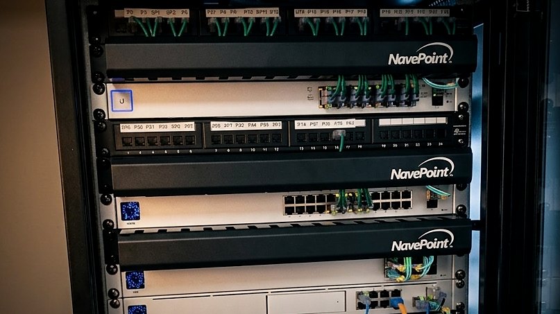 Wall-mounted cabinet with switches and patch panels